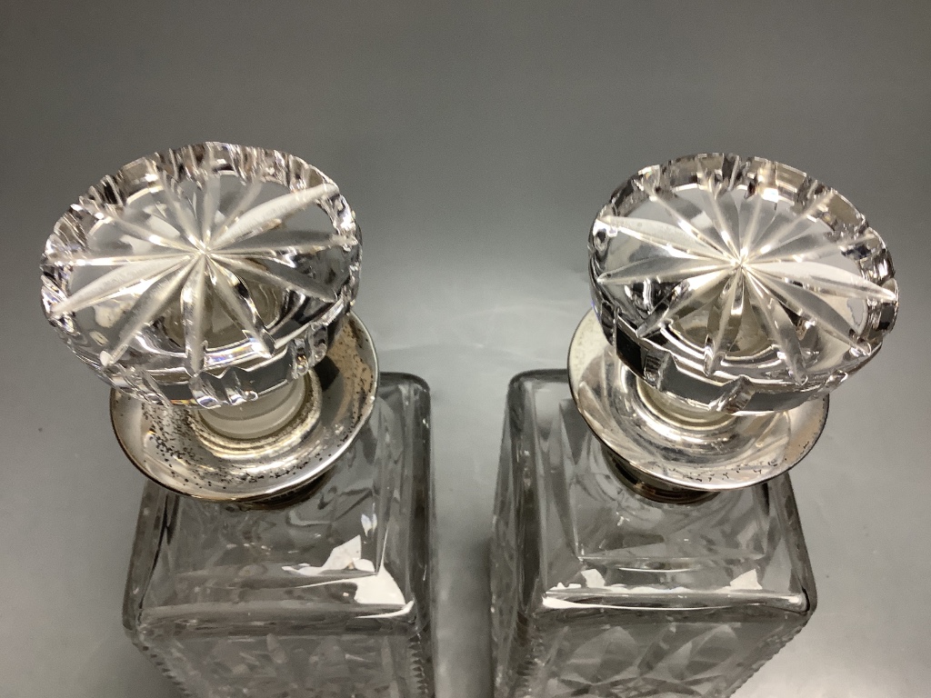 A pair of silver collared cut glass decanters, height 27cm